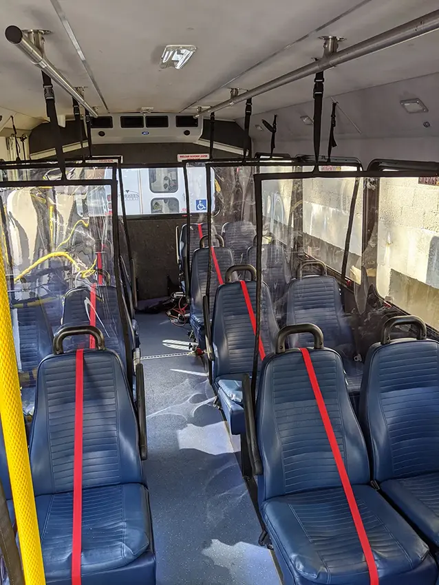Multiple Soft Shield panels installed upright throughout a commercial passenger bus